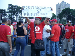 Caption: A Chavez supporter holds a sign during a rally in Caracas, Credit: Ruxandra Guidi