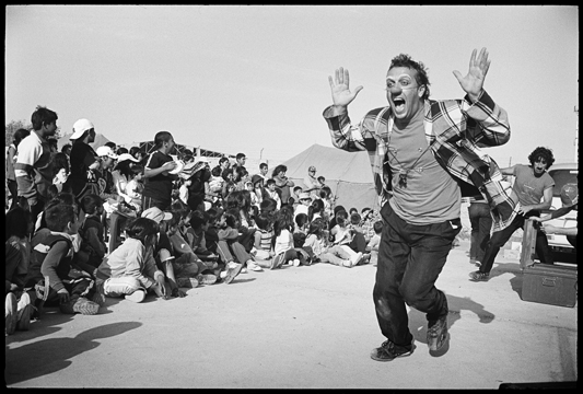 Caption: Moises Tiana during a clown performance in Pisco, Peru, Credit: Roberto "Bear" Guerra