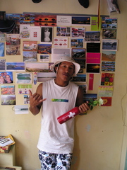 Caption: Fredy and his wall of postcards