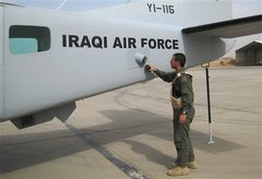 Caption: An Iraqi pilot inspects his aircraft after a graduation ceremony in Kirkuk., Credit: Photo courtesy of the Associated Press.
