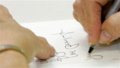 Caption: An American civilian writes to a soldier in Iraq., Credit: Associated Press