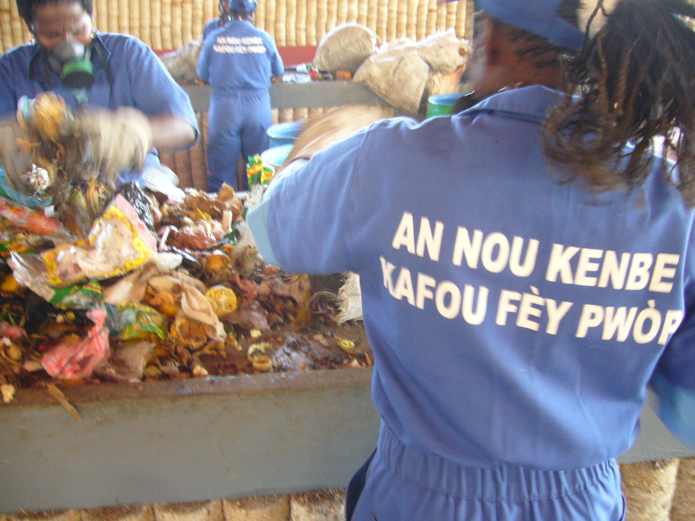 Caption: Workers sort through garbage at the Carrefour-Feuilles recycling plant funded by India, Brazil and South Africa., Credit: Ruxandra Guidi