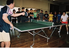 Caption: Students watch as their teachers--former ping pong champions from China, demonstrate their skills, Credit: Heidi Chang