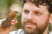 Caption: A bird in the hand: Dan Mennill and a rufous-and-white wren, Credit: Dale Morris