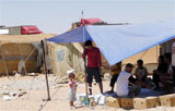 Caption: An Iraqi Palestinian family at a camp on the Syrian-Iraqi border., Credit: Associated Press / UNHCR
