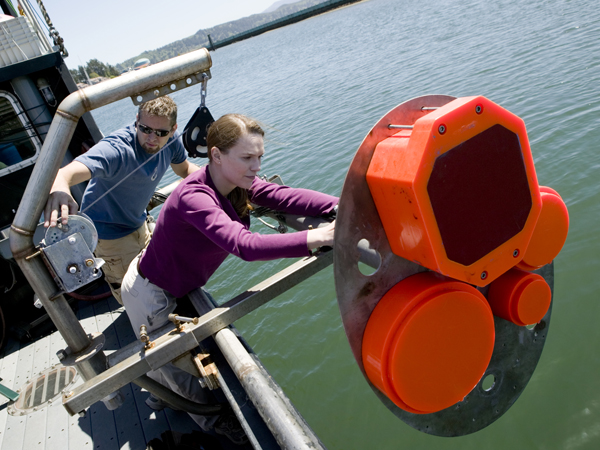 Caption: Kelly Benoit-Bird adjusting the sonar before beginning her experiment., Credit: Nick Kelsh