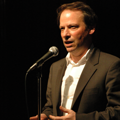 Caption: Adam Gopnik, telling a story live at The Moth.