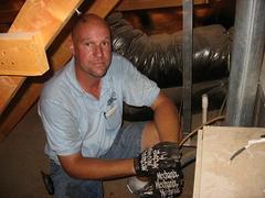 Caption: Russ Wichterman, an air conditioner service technician in Gilbert, Arizona on the rounds., Credit: Rene Gutel
