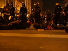 Caption: Oakland protestors lay in the position Oscar Grant was in when he was killed, Credit: Andrew Stelzer