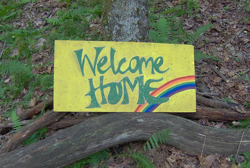Caption: A "Welcome Home" Sign from a Rainbow Gathering