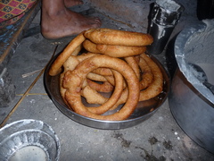 Caption: Cel roti is eaten during any festive gathering, official or unofficial, including holidays or in the presence of good company--and especially during the harvest festivals of Dashain and Tihar in October and November., Credit: Laura Spero