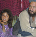 Caption: Guljumma, 7, with her father Wakil Tawos Khan, at the Helmand Refugee Camp District 5 in Kabul on August 31, 2009. Last year, an air attack by the US military struck their home in Afghanistan's Helmand Province. She lost an arm in the bombing., Credit: Reese Erlich