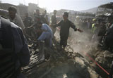 Caption: An Afghan security man asks local people to get out of the site of a blast in Kabul, Afghanistan on Thursday, Oct. 8, 2009., Credit: (AP Photo/Musadeq Sadeq)