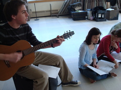 Caption: Lexington High School senior Alex Parrish leads the actors in a version of "Two-Headed Boy" by Neutral Milk Hotel, while freshman Emma Feinberg (right) sings along., Credit: Avishay Artsy