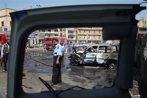 Caption: The aftermath of a car bomb near Al-Rashid Street in 2004., Credit: Photo courtesy of the Associated Press.
