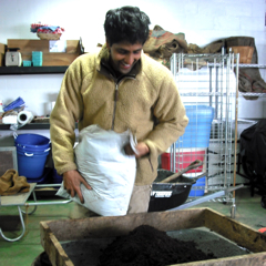 Caption: Sunil Patel Sifts Compost, Credit: Emily Reddy