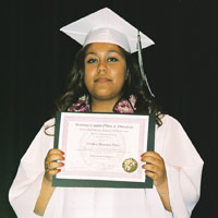 Caption: Claudia Villa with her high school diploma