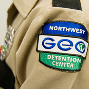Caption: GEO Guard at the Northwest Detention Center, Tacoma., Credit: Alex Stonehill