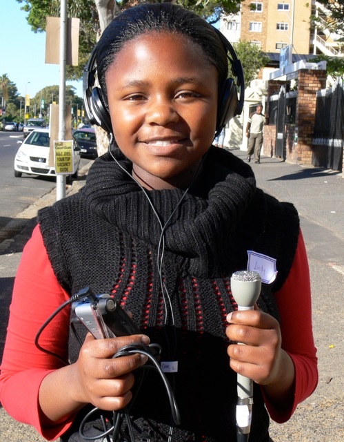 Caption: Lindy Hlobo ready to do some interviews near Cape Town's Greenpoint Stadium, Credit: Photo by Kate Streek
