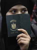 Caption: An Iraqi women holding her passport. , Credit: Photo courtesy of Reuters.