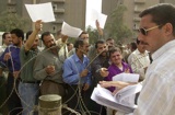Caption: Iraqis submitting job applications., Credit: Photo courtesy of AP.