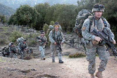 Caption: Army Pfc. Ronald Craig (R) and<br> fellow soldiers in 3rd Platoon,<br> Combat Company, 1-32 Infantry,<br> return from a two-week patrol <br>in Afghanistan., Credit: Army Spc. Jon H. Arguello