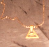 Dije protector ojo de Ra en oro de 10kts
