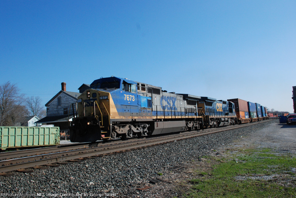 CSX 7673 takes doublestacks through Wellington.