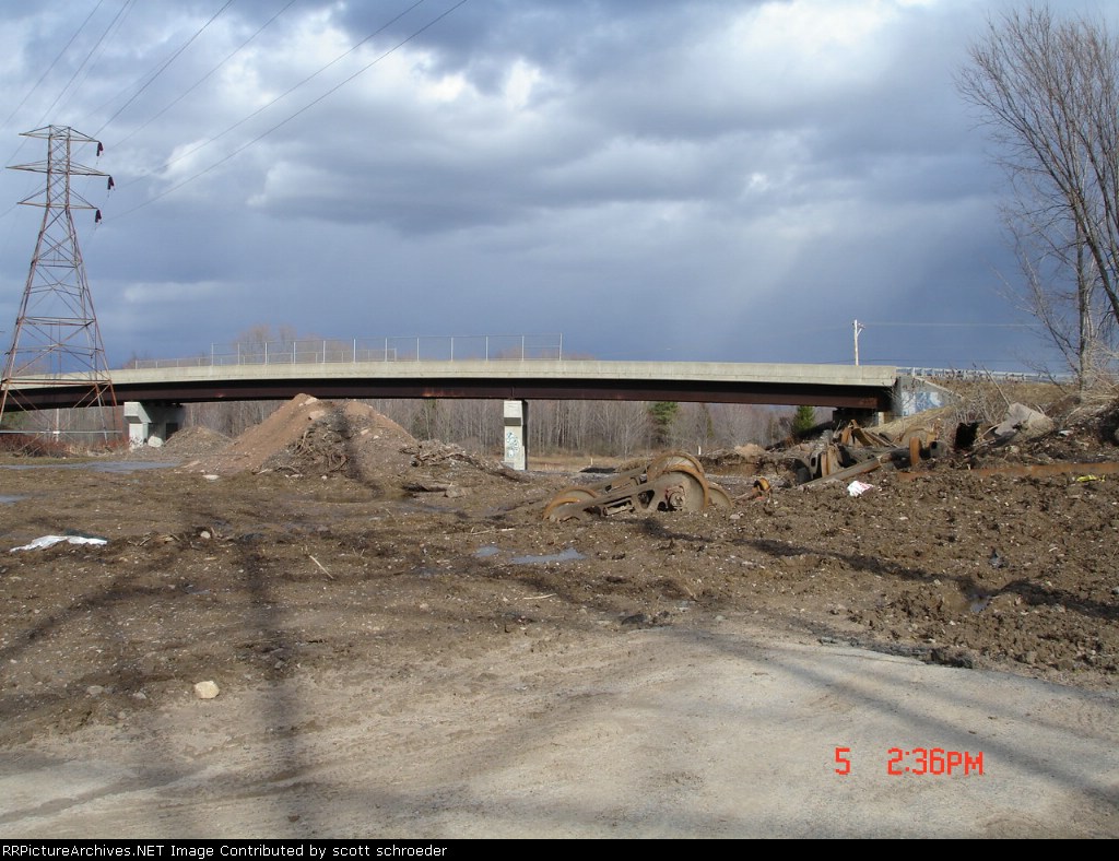 Axles & Trucks amongst the debris looking towards the Rte. #11 Bridge
