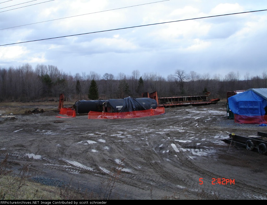 2 Procor (PROX) Tankcar's fenced off in a muddy field