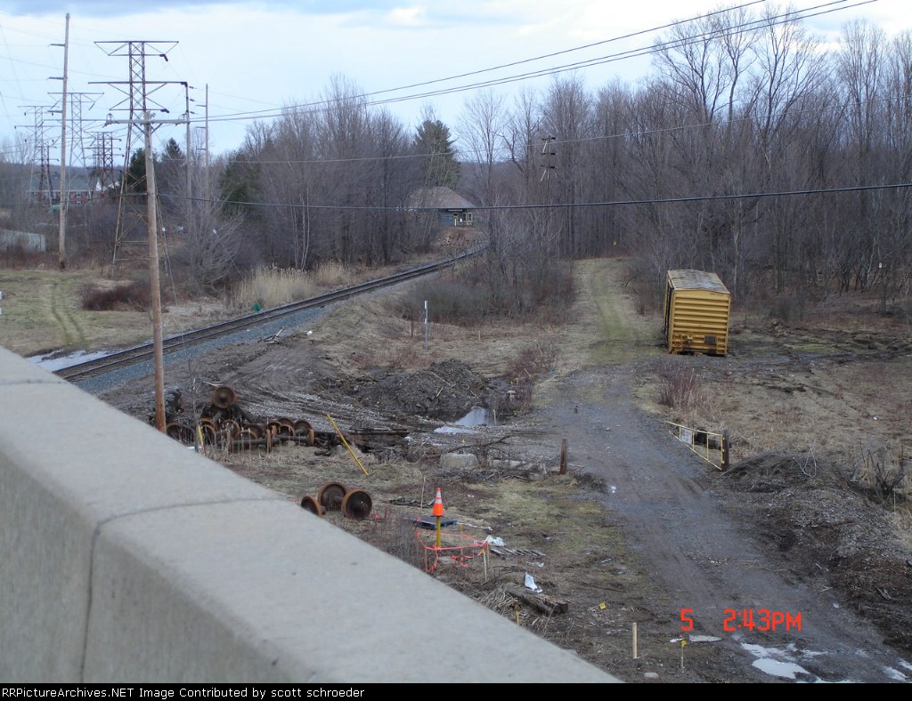 Railbox (RBOX) Boxcar missing the trucks alongside the main looking north