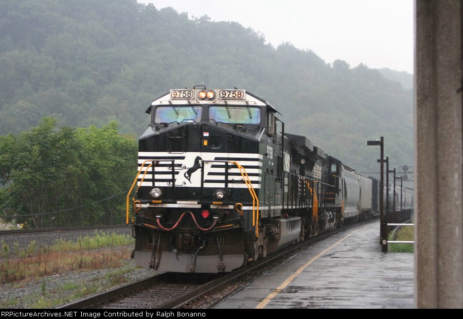 Eastbound 10G rolls through the station amidst a downpour