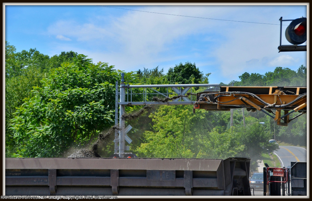 Putting the dirt into the side dump gon.
