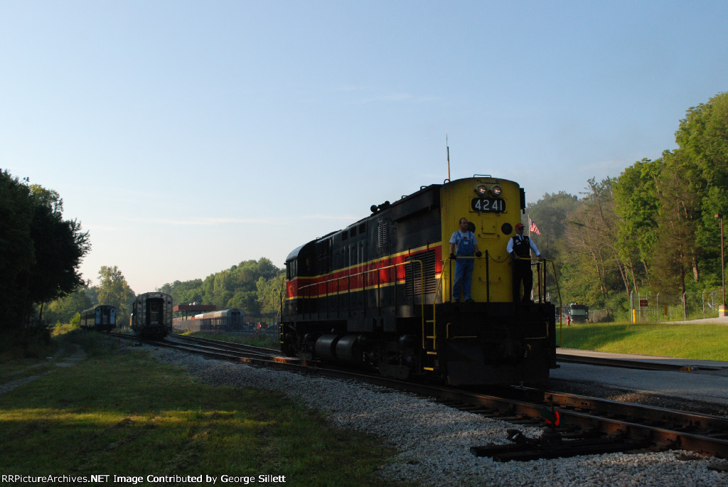 4241 backs up ti tie onto its scenic train.