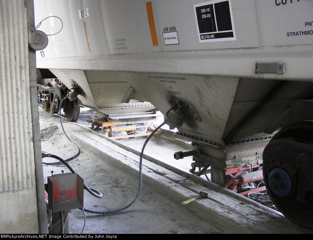 The car vibrators hammer away as CRDX 21042 empties another load of portland cement