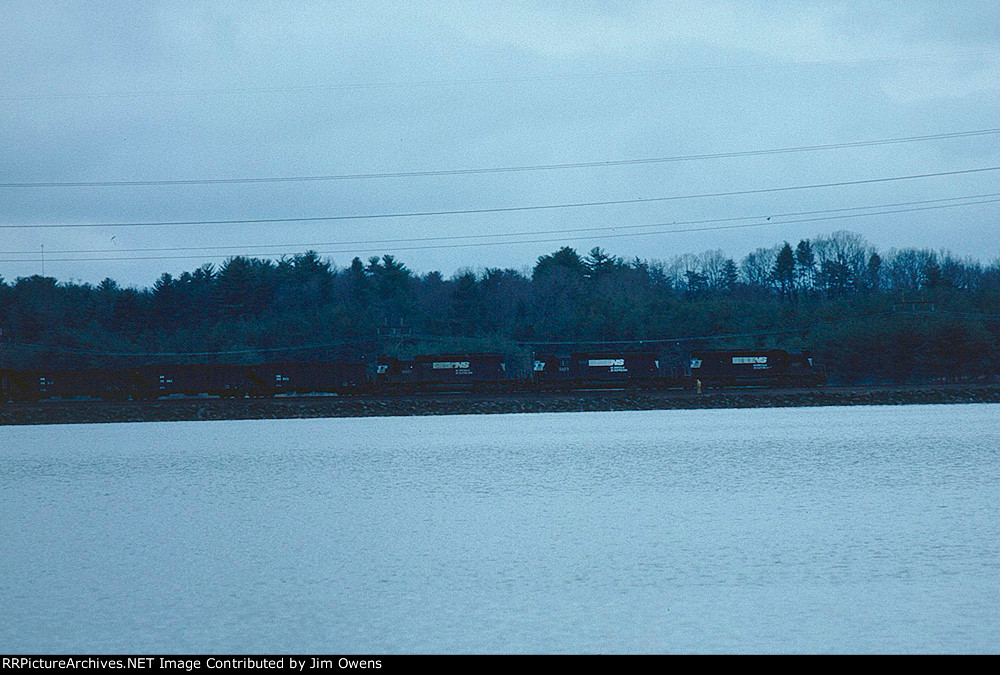 A coal train for the Asheville Steam Plant rolls around Lake Julian to arrive at the plant.
