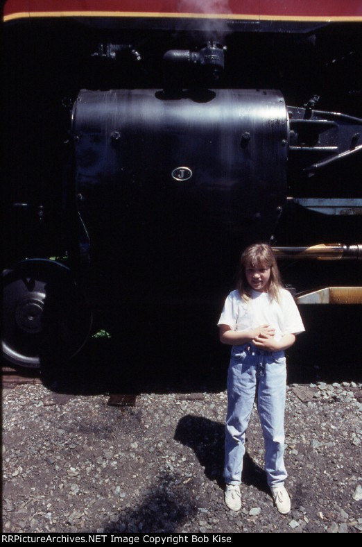 My daughter stands by the cylinders