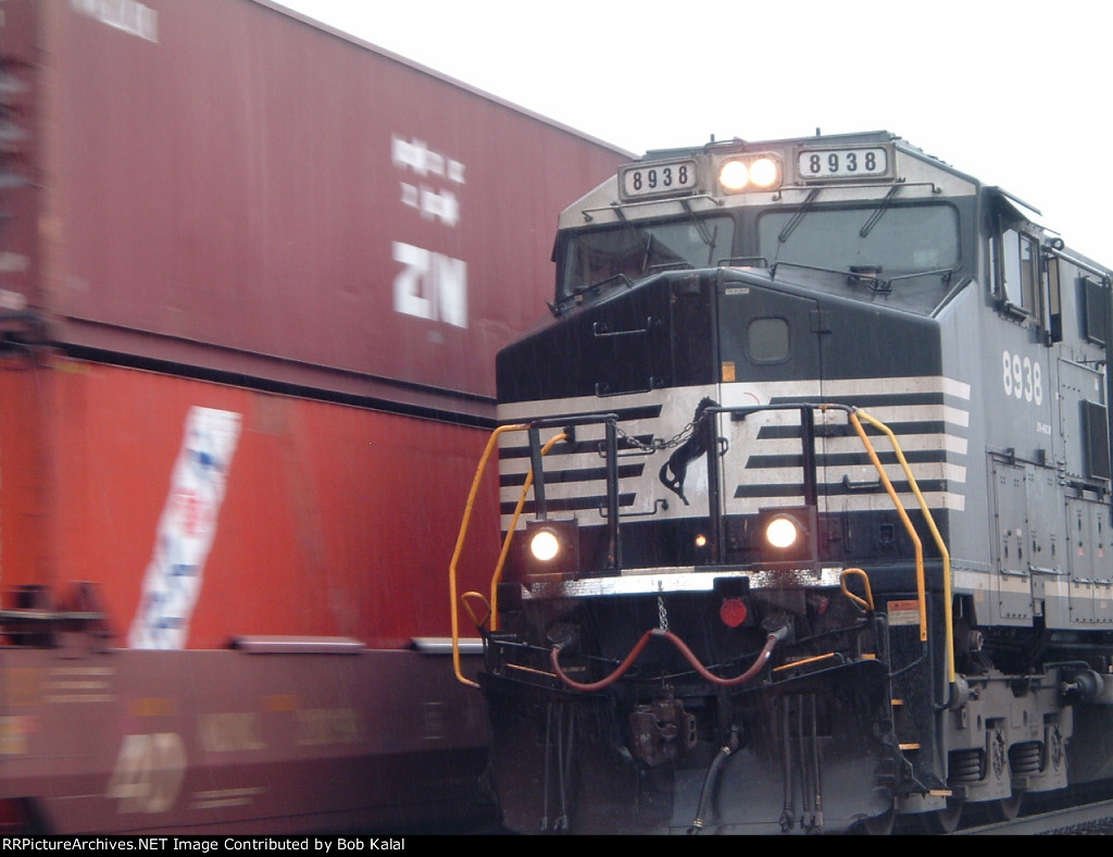 NS 8938 hooked to cars waiting for other freight train to go by  to head north