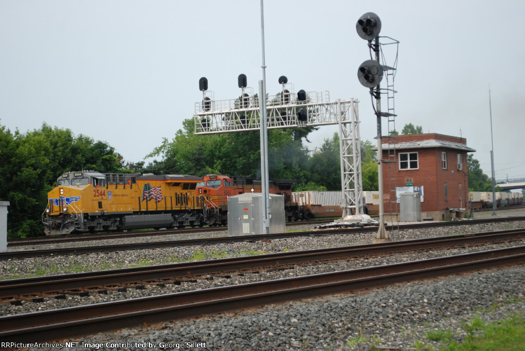 UP, and BNSF power takes an intermodel train west.