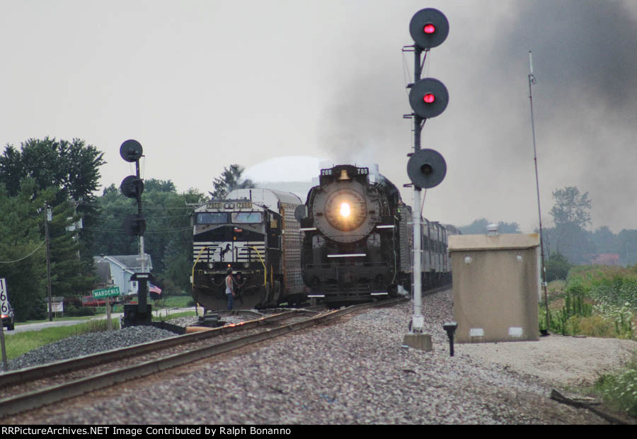Running around an auto rack train as the train rolls past the Wabash interlocking signals