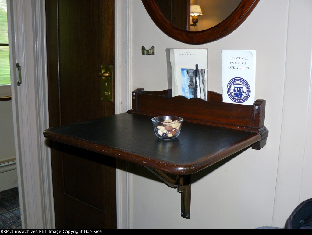 The writing desk with a bowl of assorted nuts/dried fruit