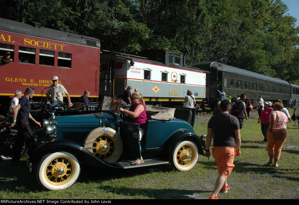 A mix of nostalgic train cars and automobiles