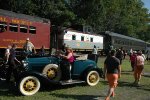 A mix of nostalgic train cars and automobiles