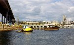 Western Towboat heads south up the channel while a UP freight waits for the bridge to close