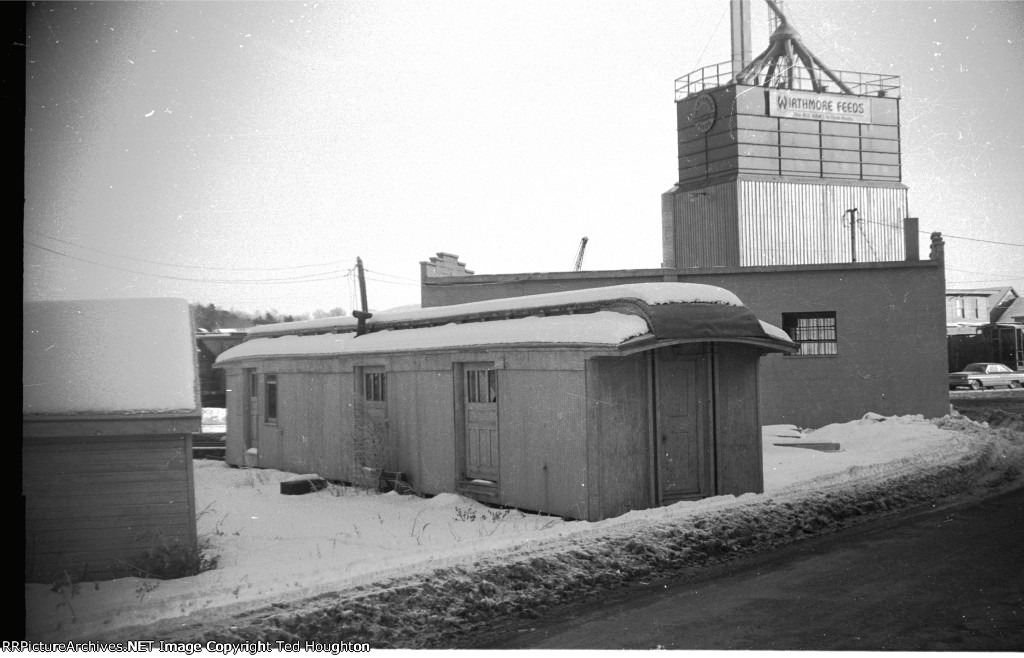 Old baggage car reduced to a storage shed.