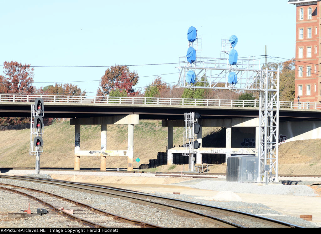 This view shows the current NS "H" line signal on the left, the new signals for the passenger station (blue bagged, 2 tracks) and far right is the track for the NS & CSX yards