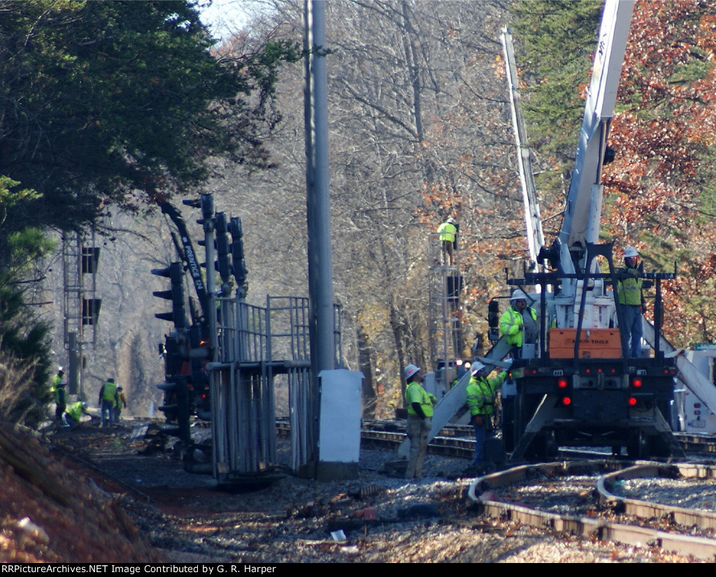 Signal bridge on the ground and out of the way.  Signal gang in the distance prepares the northbound signals for service
