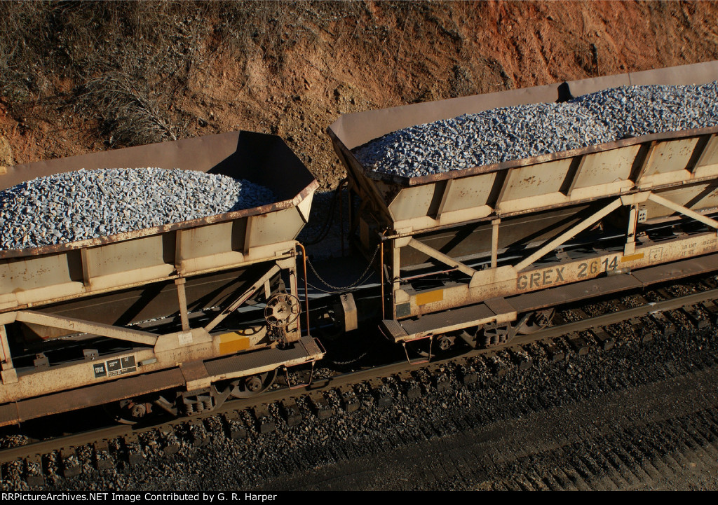 Conveyor belt that moves rock from the cars to the rear of the train is seen