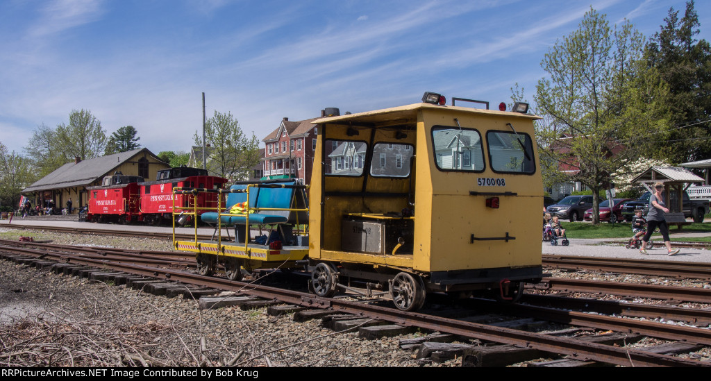 Fairmont Model A-4 motorcar towing a track maintenance flat car modified with benches and railing