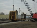 Manitowoc Crane unloading flatcar of BIG metal rings of some sort
